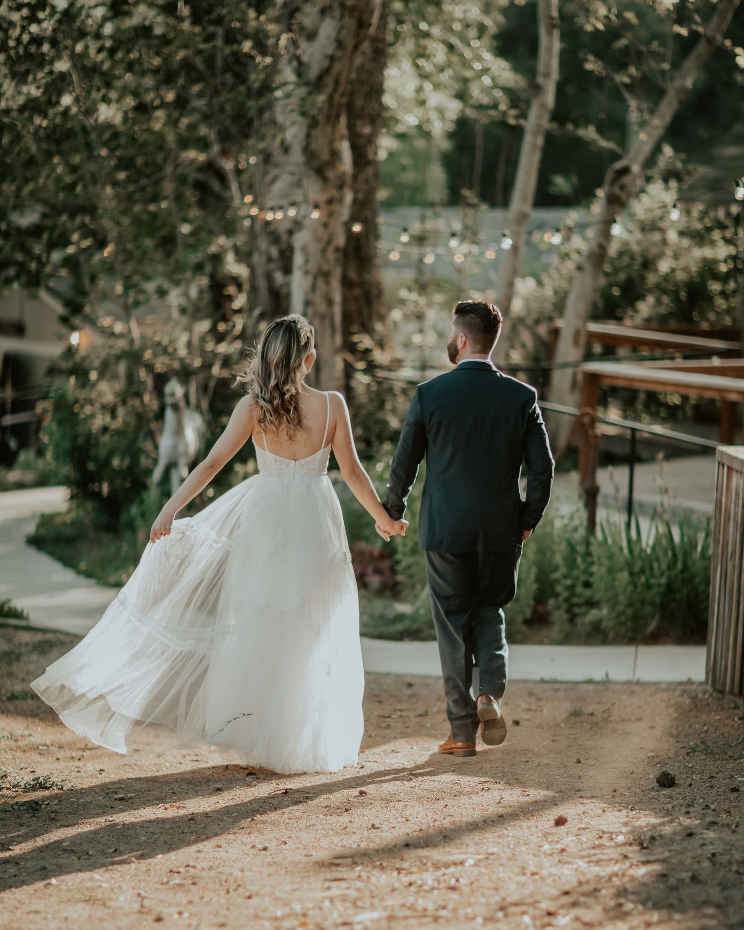San Diego wedding photography of Bride and Groom enjoying time alone walking down a garden path together.