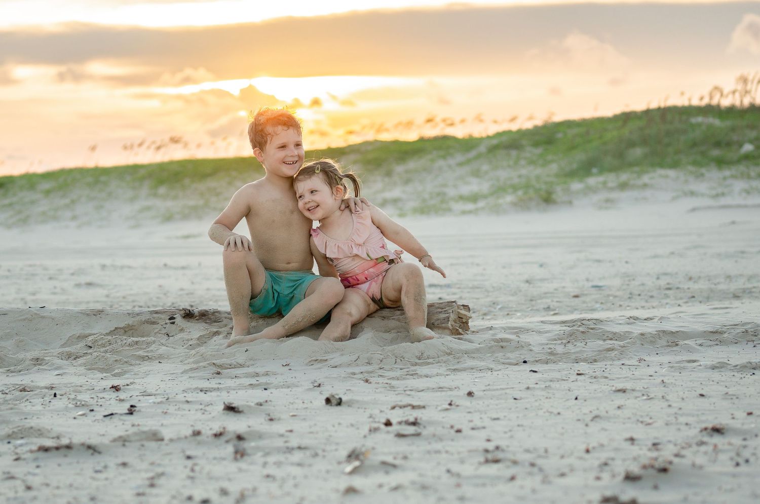 Sister holds her new baby brother in a Fresh 48 Photo Session in Victoria, TX.