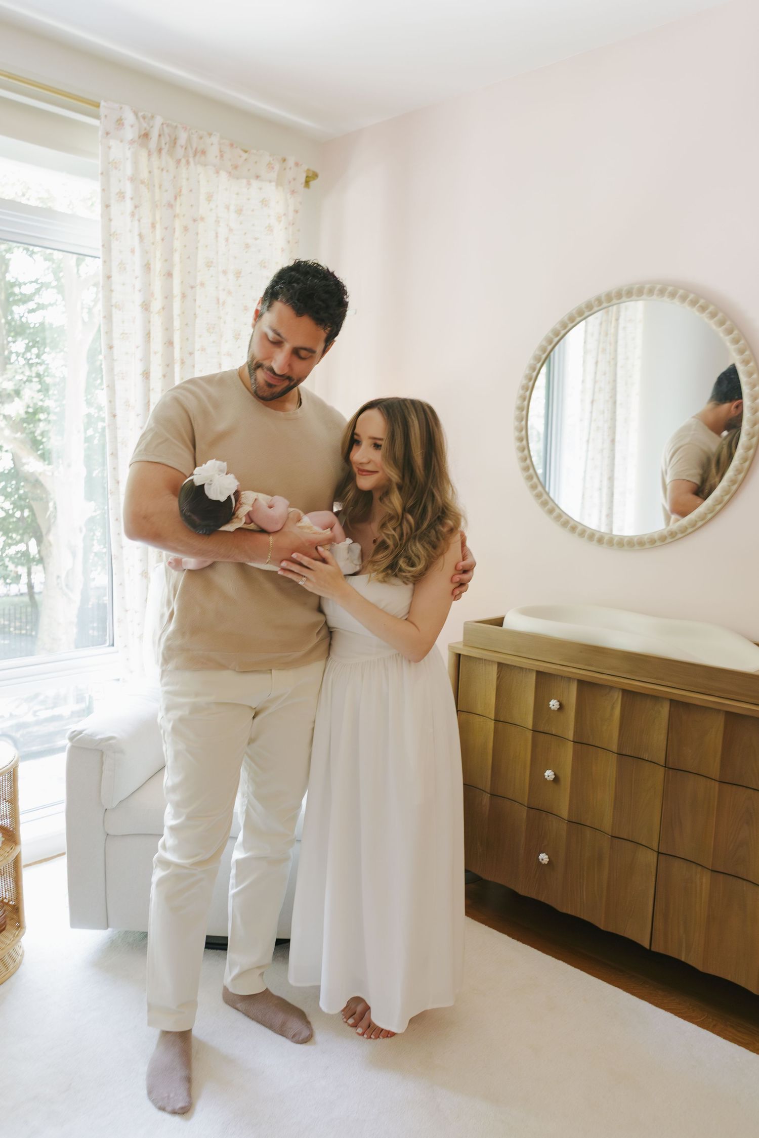 Paula Brearley, NYC family photographer, photographing a newborn at home with parents in a cozy lifestyle session
