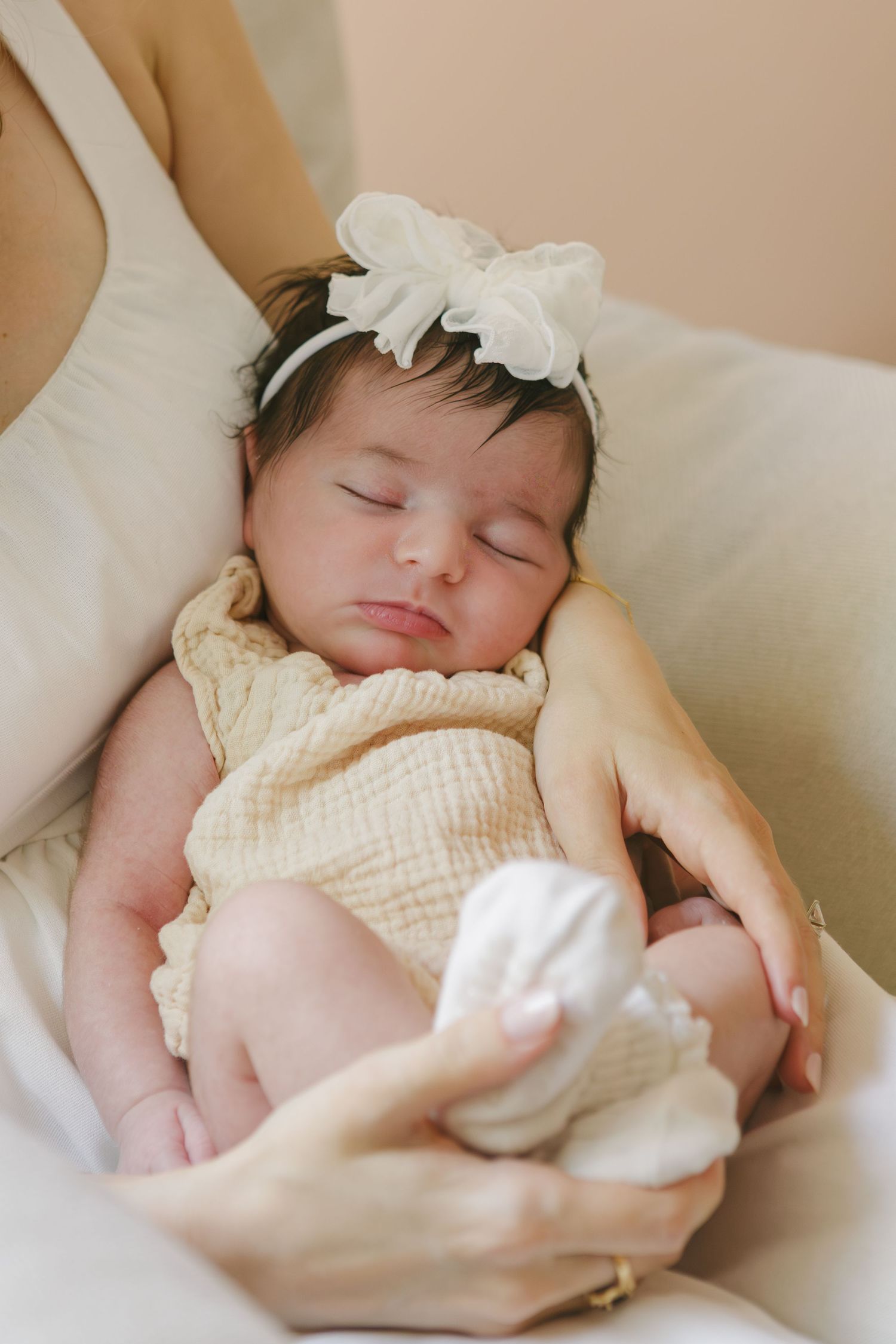 Lifestyle newborn photography at home in New York City by Paula Brearley, focusing on tender family connection.
