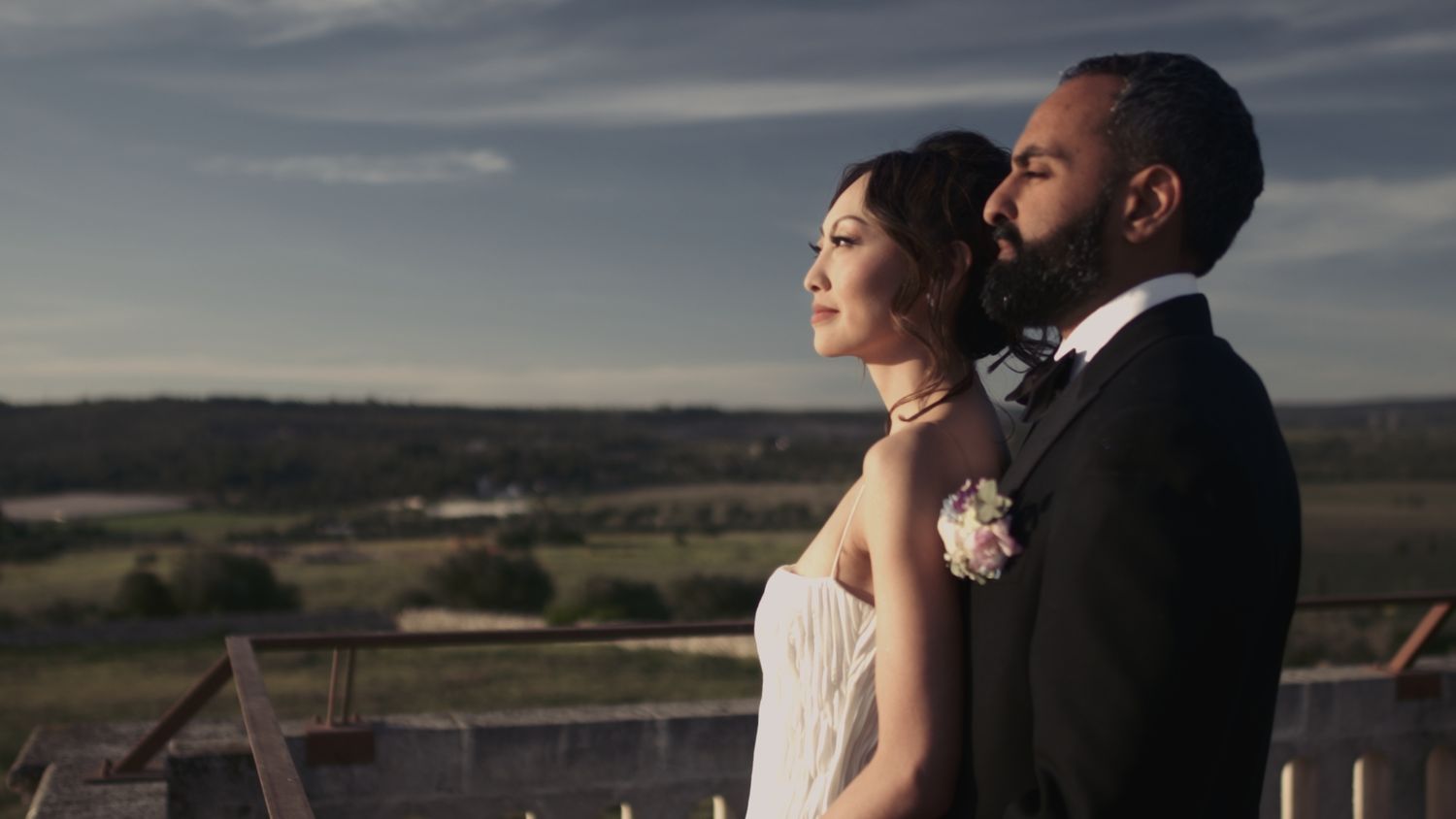 Bride & Groom look at the sunset in a countryside in Puglia