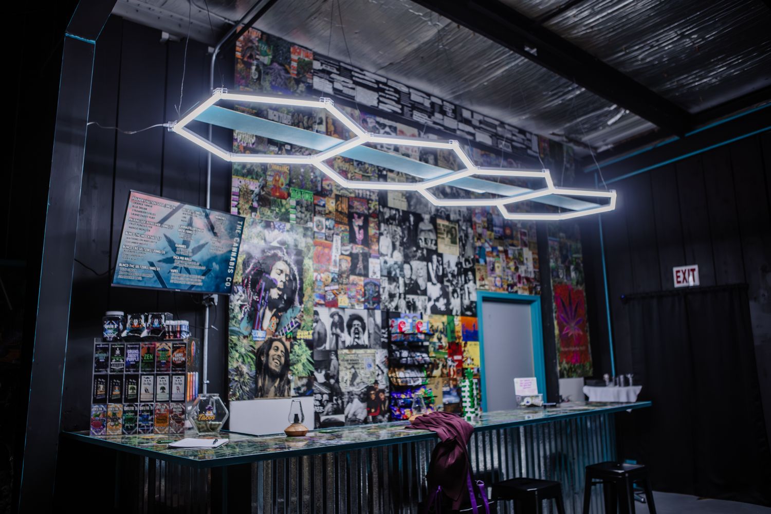 Modern retail space with geometric LED lighting fixtures on black ceiling.