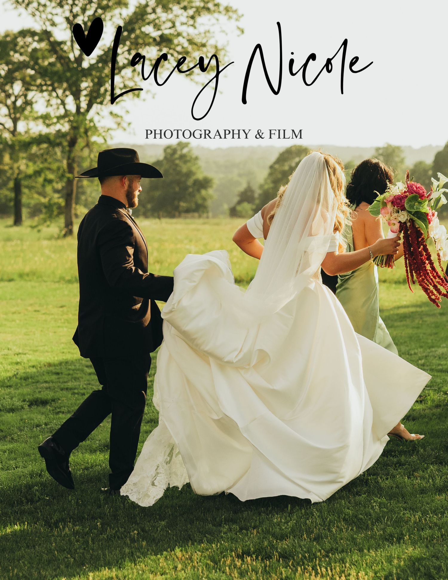 A bride in a white gown and groom in black hat walk outdoors with a bridesmaid holding a bouquet at a wedding.
