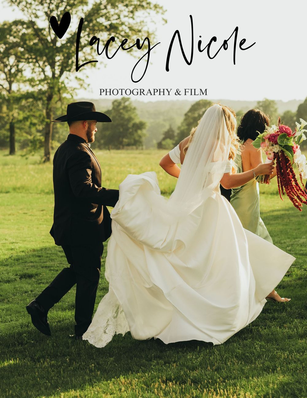 A bride in a white gown and groom in black hat walk outdoors with a bridesmaid holding a bouquet at a wedding.