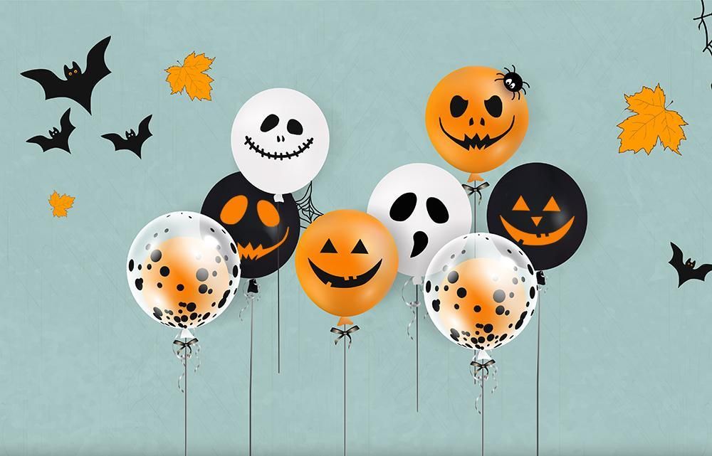 Three children in matching yellow ruffled outfits pose in spooky Halloween setting.