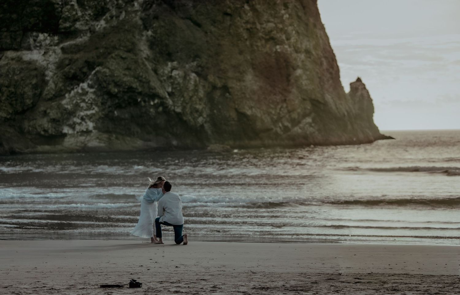 A series of scenic beach photos showing a dramatic proposal moment silhouetted against a cloudy sunset.