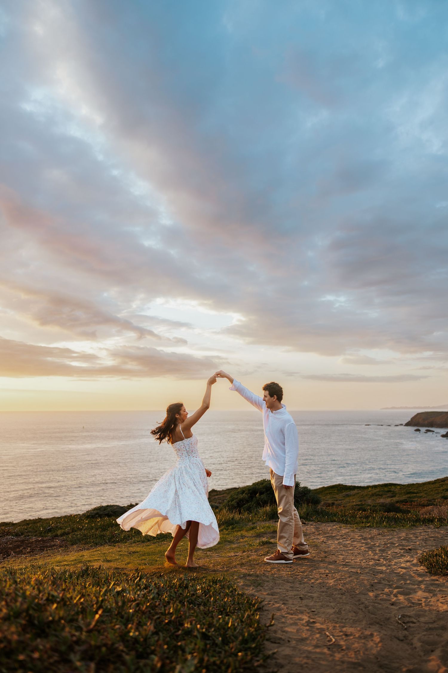 a man proposing to his girlfriend on a bed of pink and white rose petals overlooking the Palace of Fine Arts in San Francisco