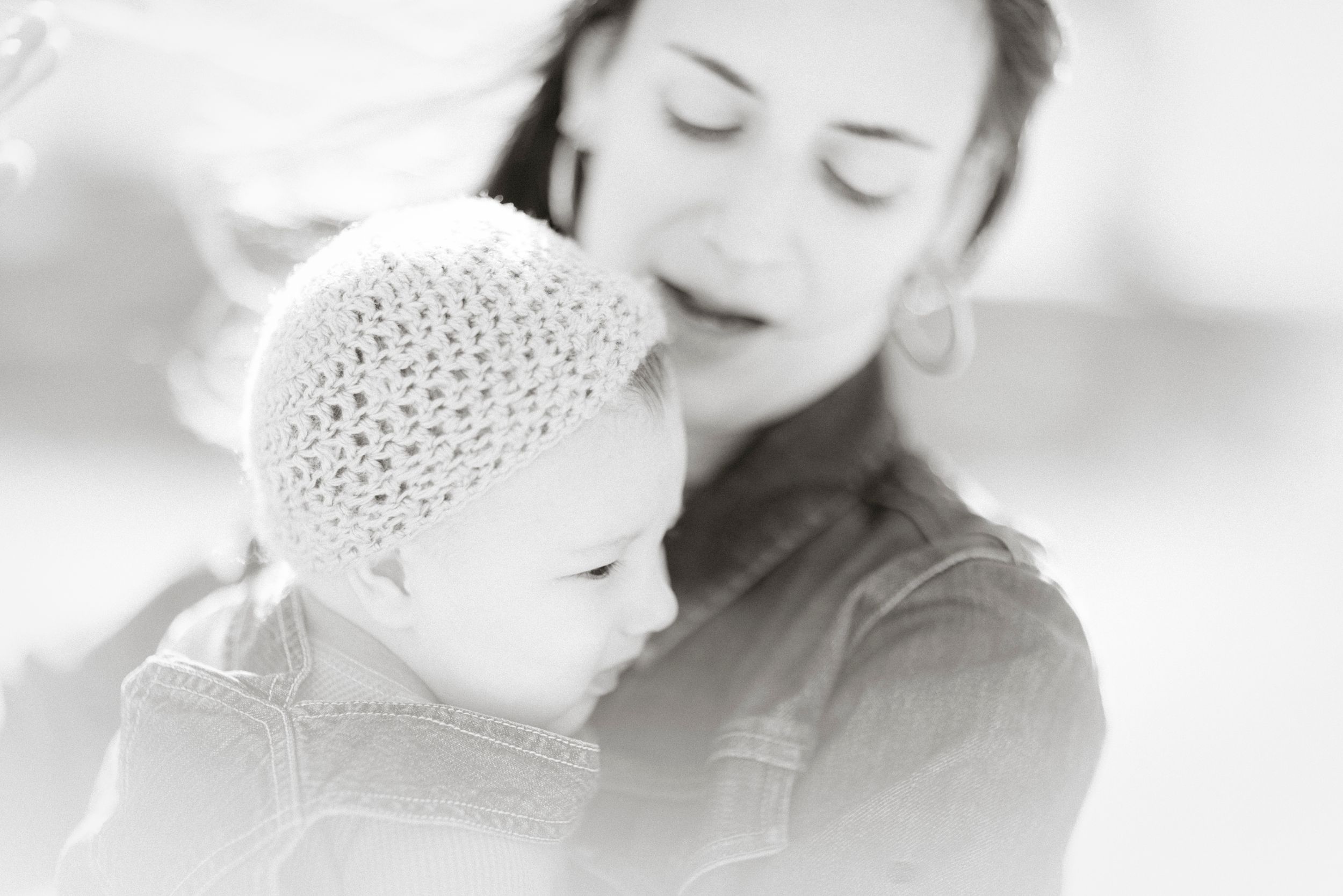 Black and white portrait showing tender moment between two people.