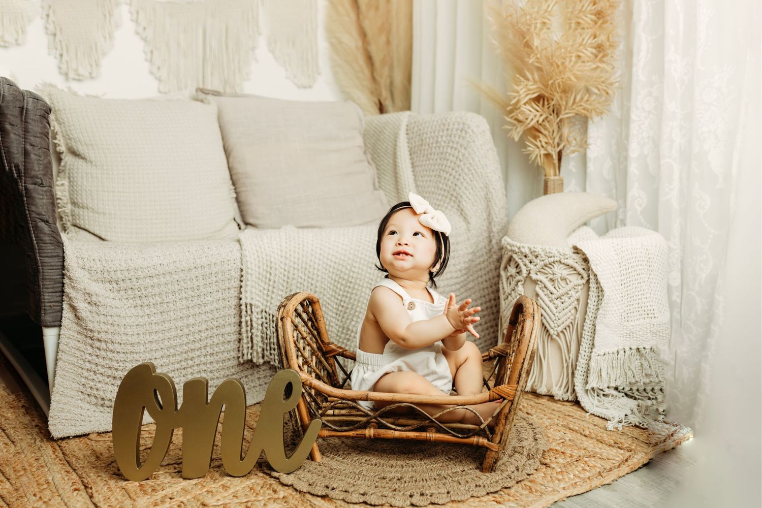 Neutral toned nursery setup with rustic wooden props and soft textures.