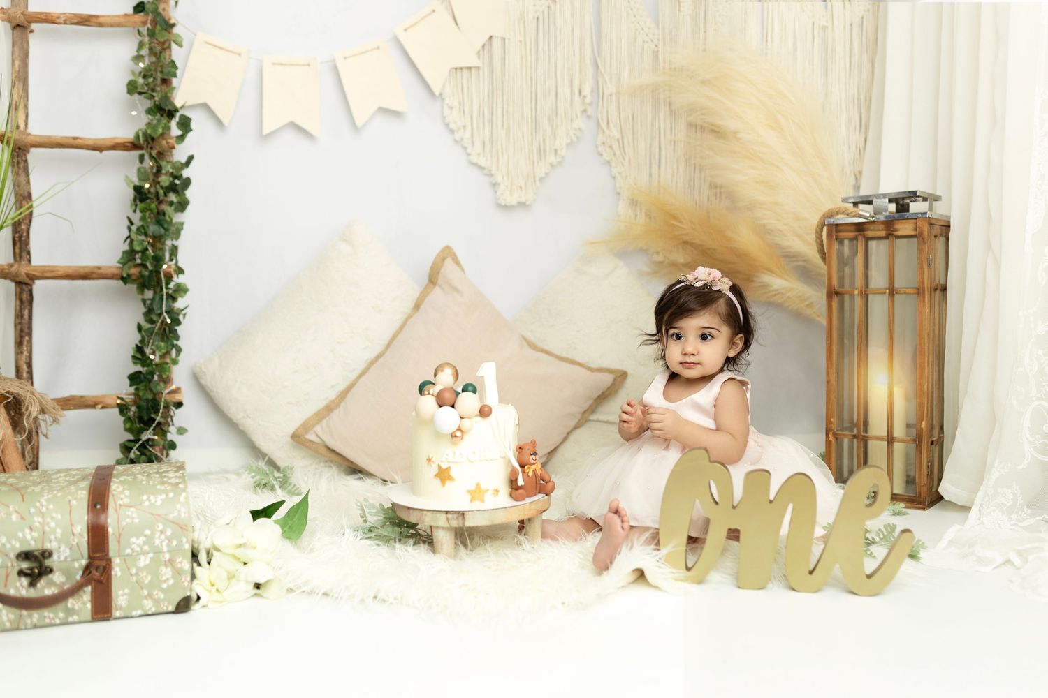 Rustic chic birthday photo setting with gold lettering and natural elements.