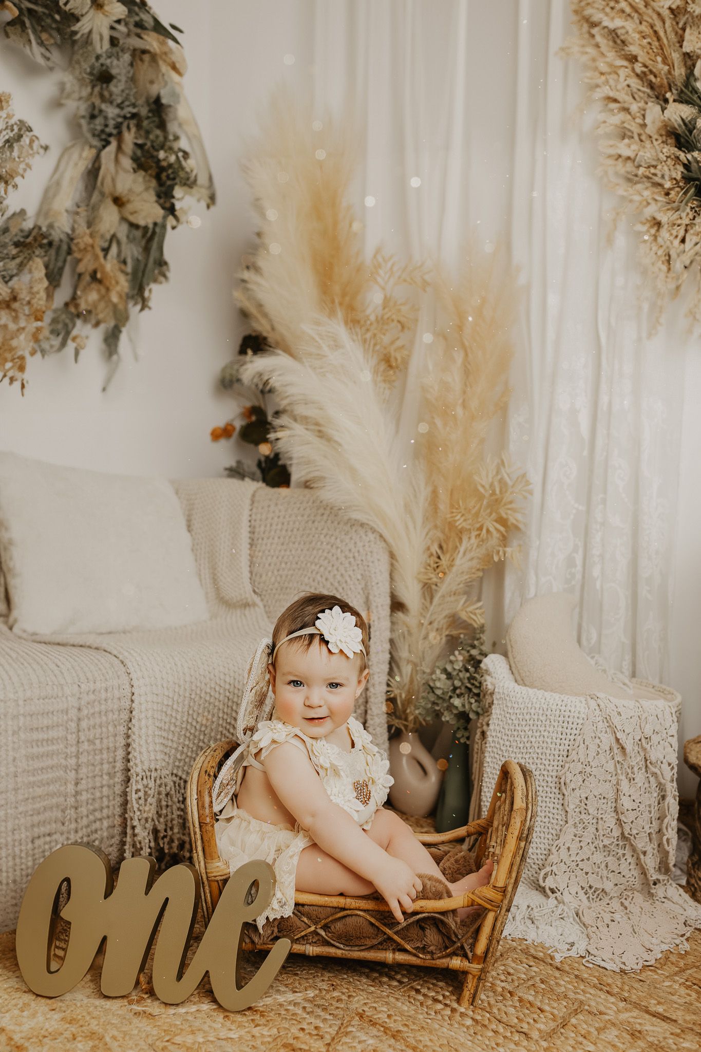 Boho-style photography setup with dried pampas grass and neutral tones.