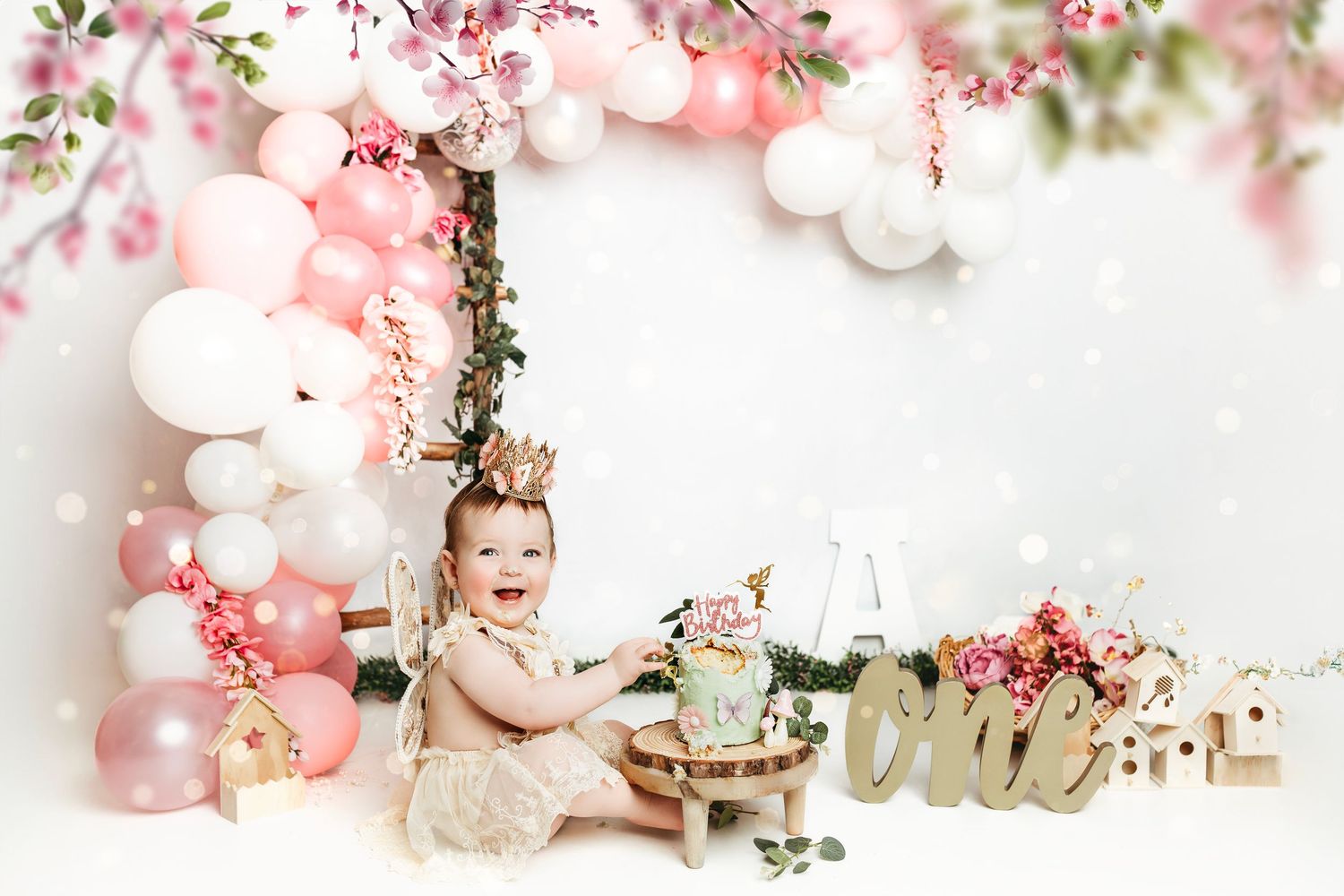 Spring-themed photo setup with cherry blossoms and white decorative elements.