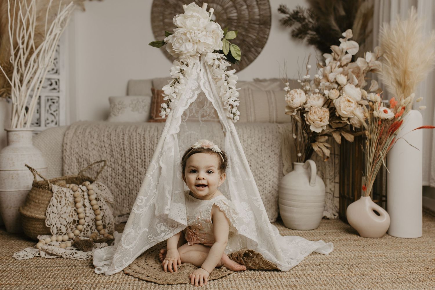 A collection of vintage-style baby photography scenes with lace, white decor, and soft neutral tones arranged in a collage.