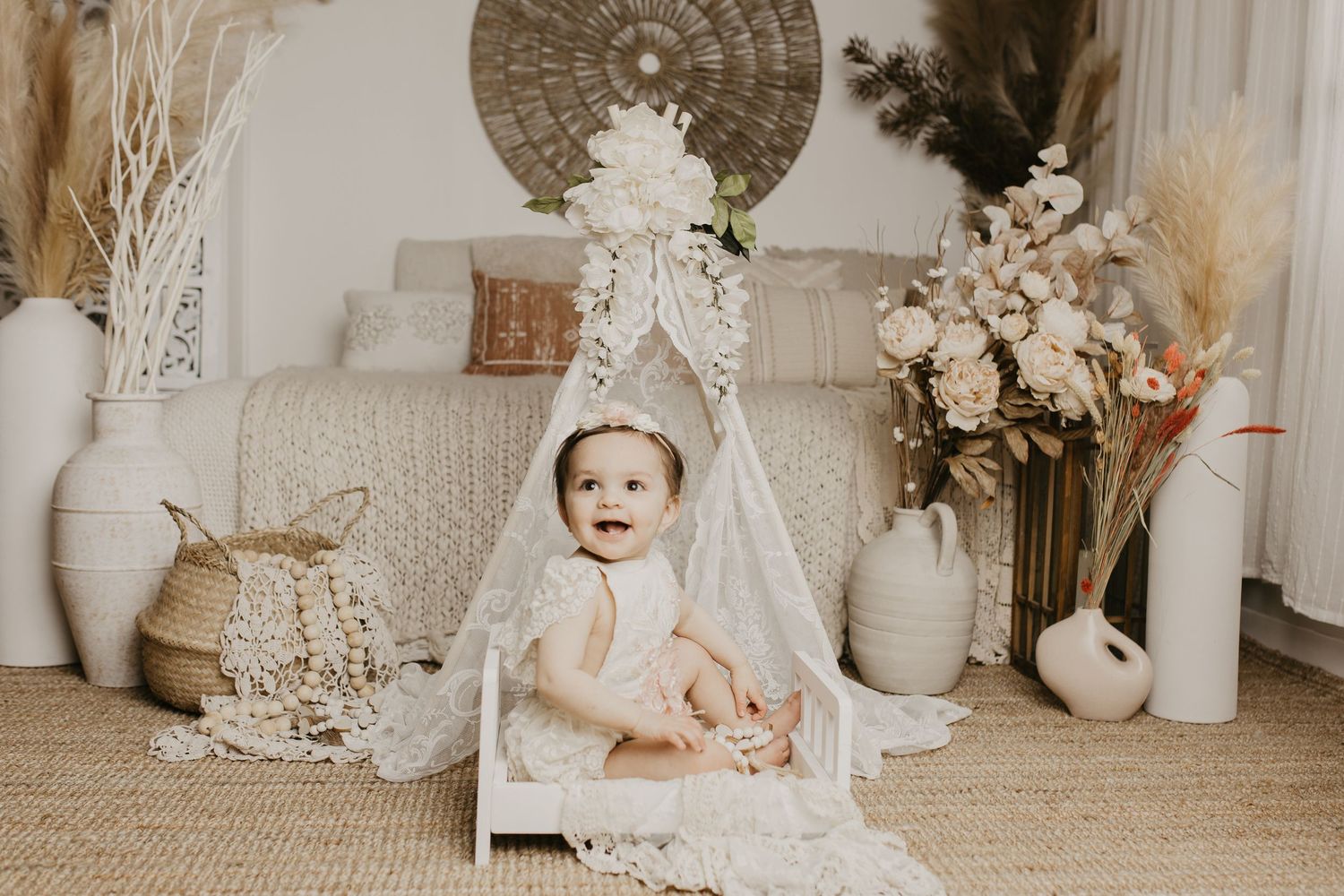 A collage of vintage-inspired baby photos with soft beige tones, floral arrangements, and decorative elements.