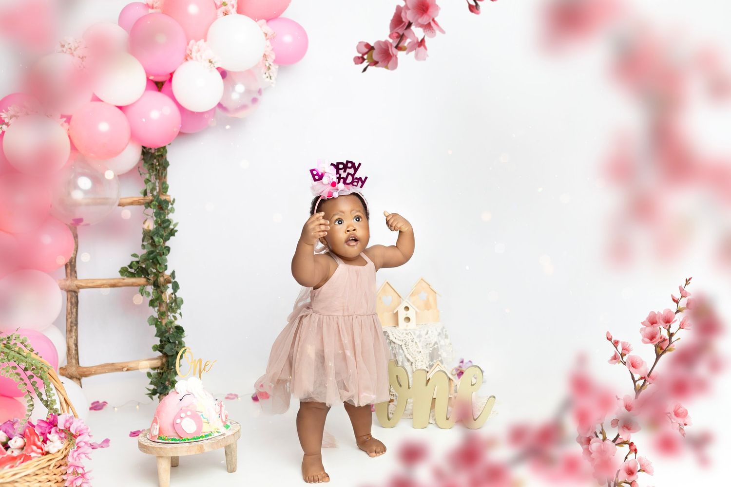 Whimsical pink photography setup with blurred bokeh effects and decorative elements.