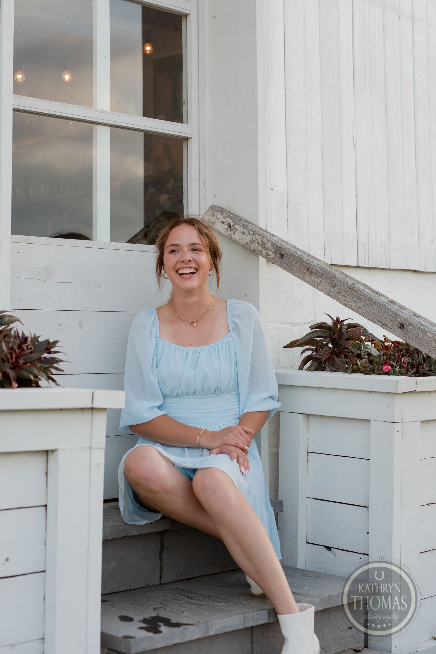 A vintage-inspired photo shoot on white farmhouse steps features a light blue summer dress.