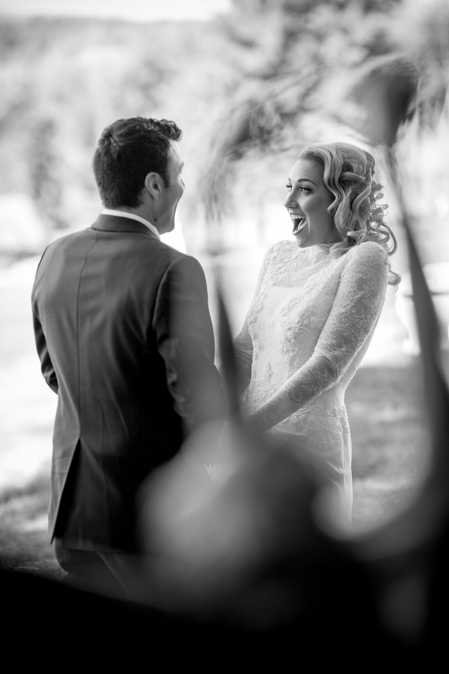 Black and white wedding portraits showcase intimate moments between newlyweds.