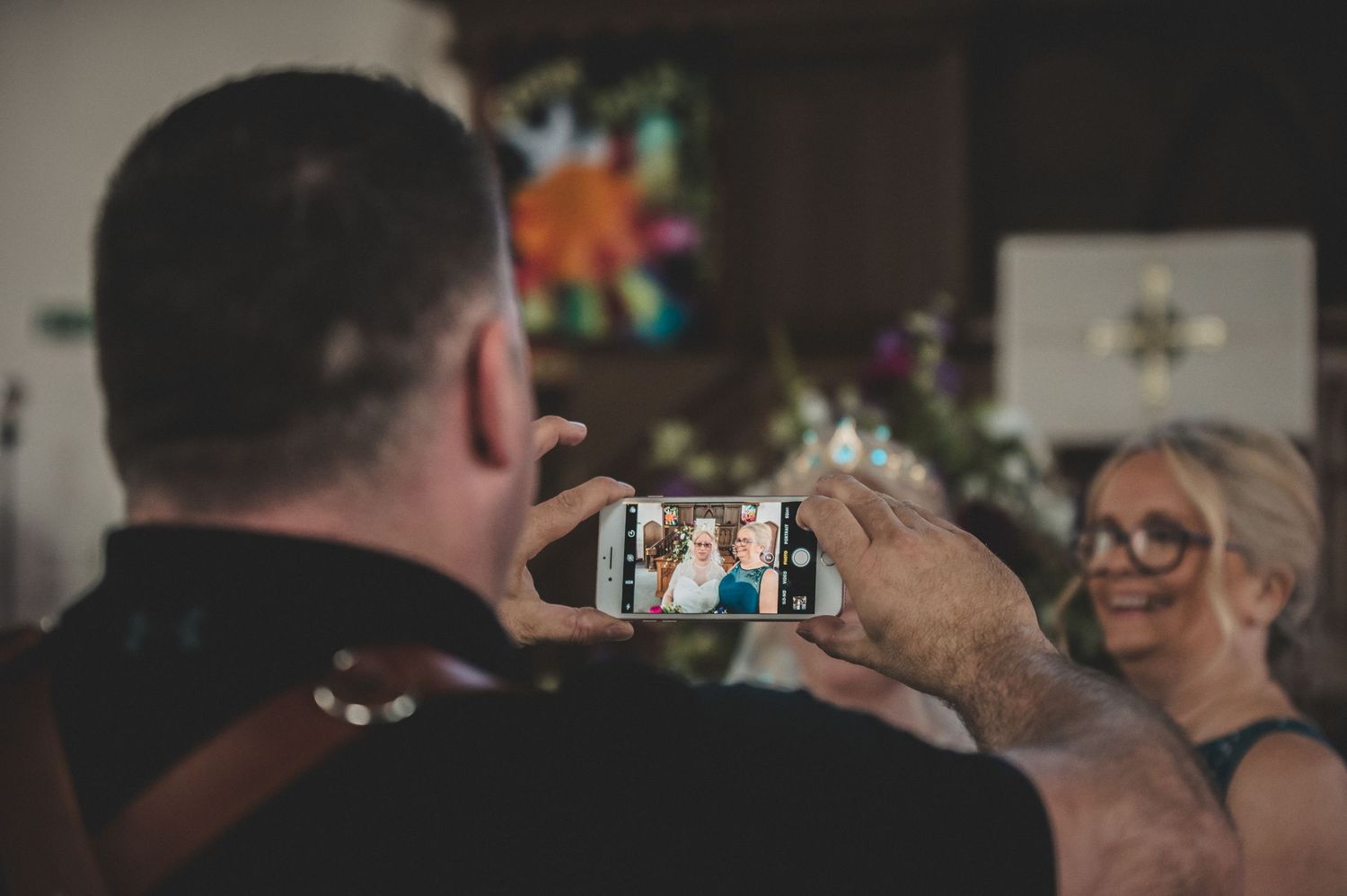 Behind the scenes photo of capturing a candid moment at a celebration.