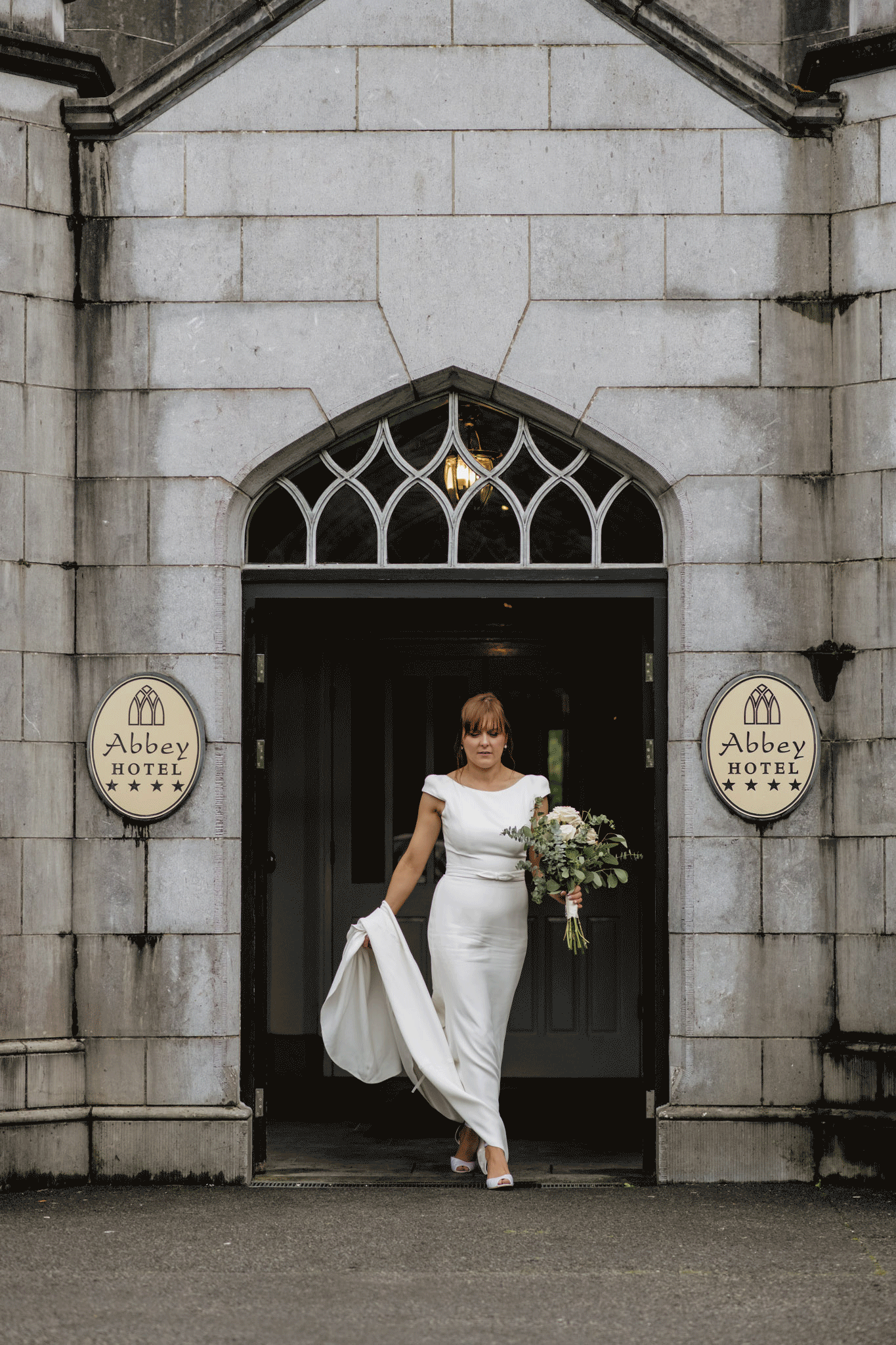 Bride doing red carpet walk and turning back in front of hotel entrance in county Roscommon. moving gf.
