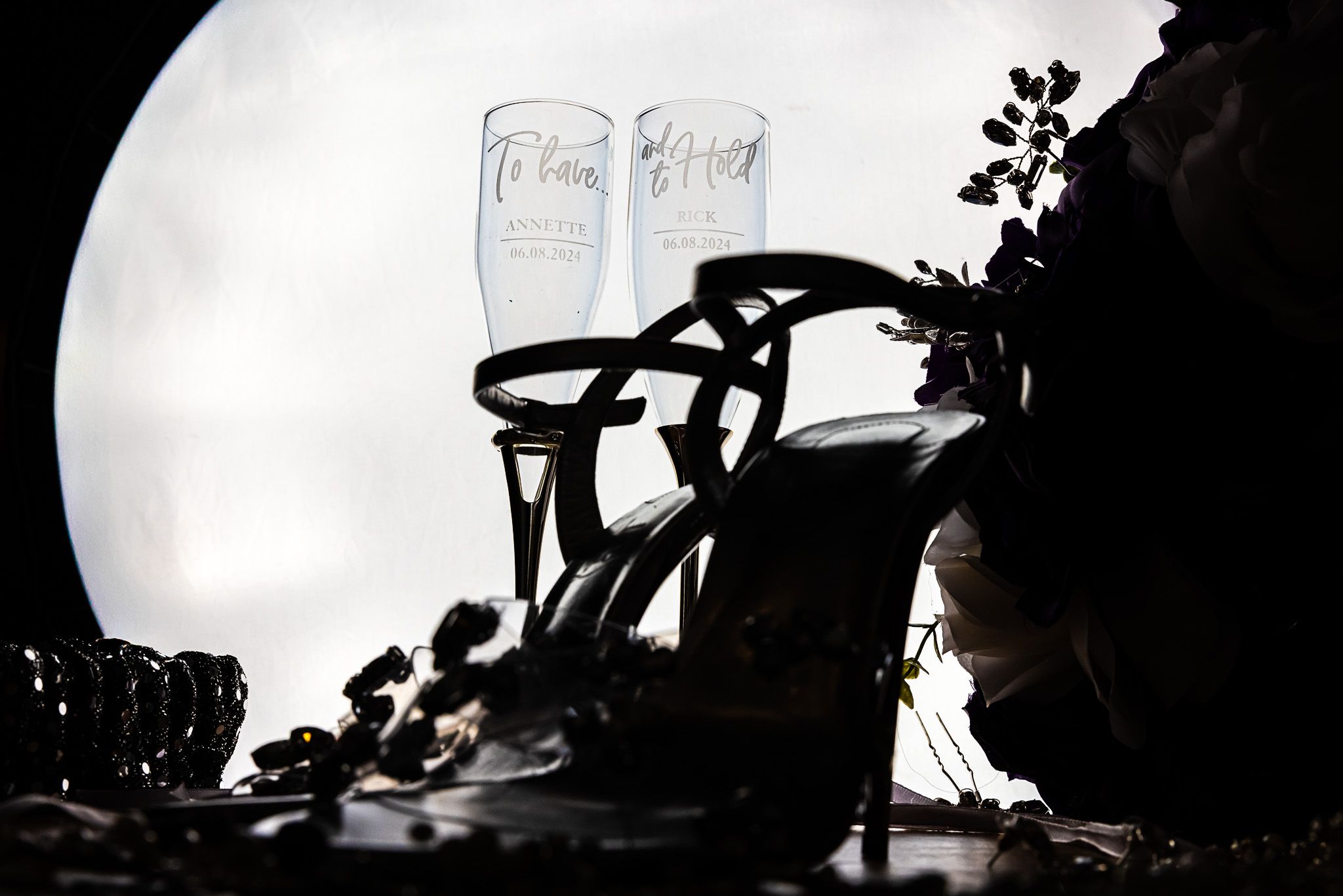 Silhouettes of wedding decorations and floral arrangements against a bright background.