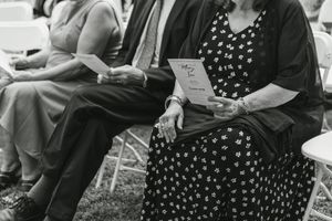 Black and white photo of guests mingling at a social gathering.