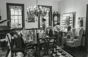 A black and white panoramic collage showing interior views of a gym or fitness center with various exercise equipment.