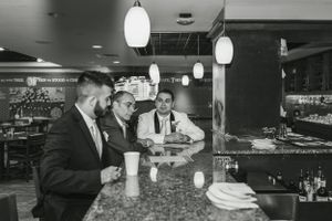 Vintage style black and white photo at a bar counter with pendant lighting.