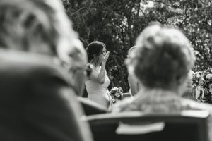 Black and white photo of an outdoor ceremony from guests' perspective.