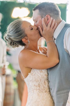 Three romantic wedding photos show a couple in formal attire sharing intimate kisses during their outdoor ceremony.