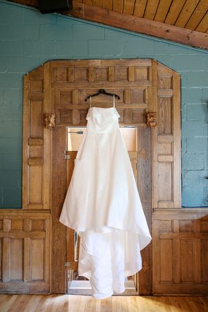 White dress floating against wooden paneled door and turquoise wall in five sequential artistic photographs.