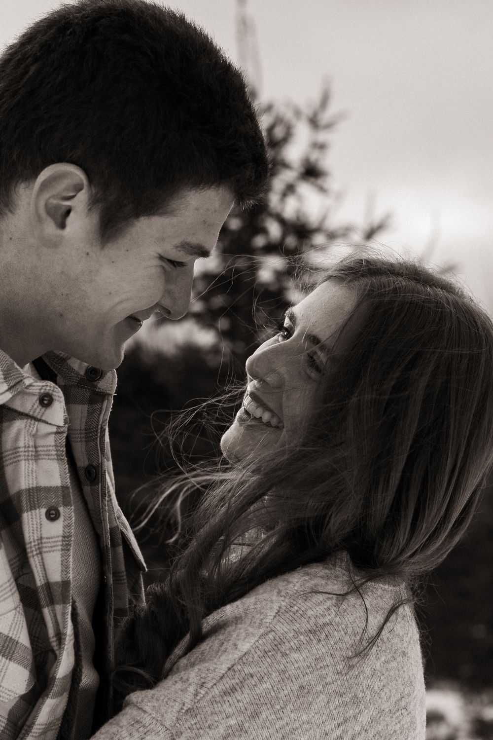 A romantic black and white photo series showing a couple sharing intimate moments and laughter together.