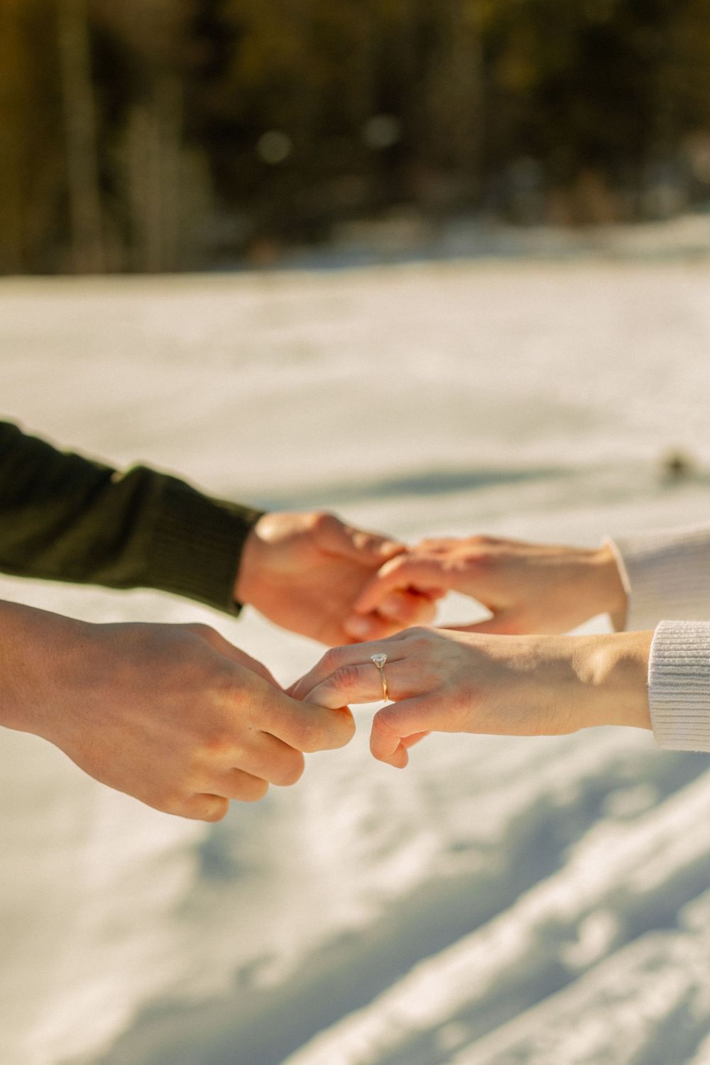 Close-up sequence of hands reaching out and touching in a gentle, connecting gesture against a bright background.