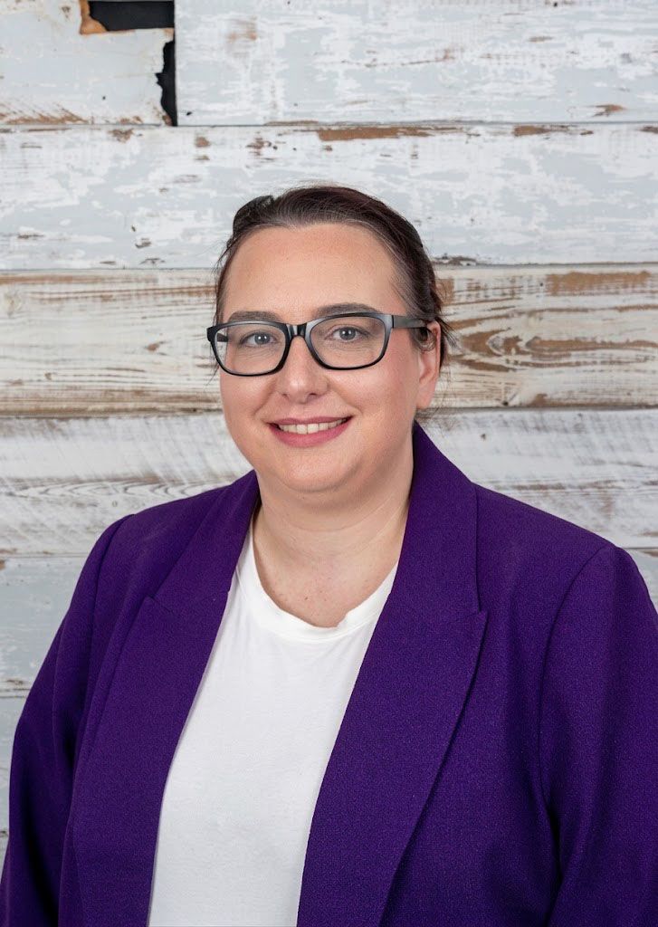 Person wearing pink t-shirt with blue blazer and red glasses in multiple poses against light background.