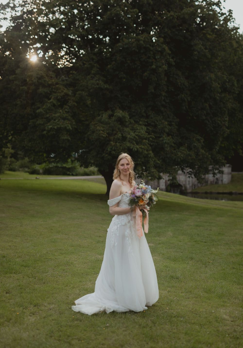 Set of five wedding photos showing a person in a white gown holding a bouquet while standing in a grassy outdoor setting.