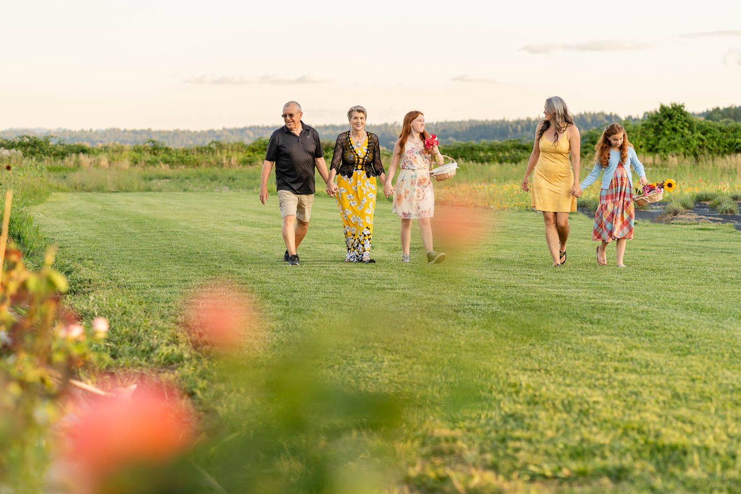 Extended family walking together in a flower field in Woodinville.