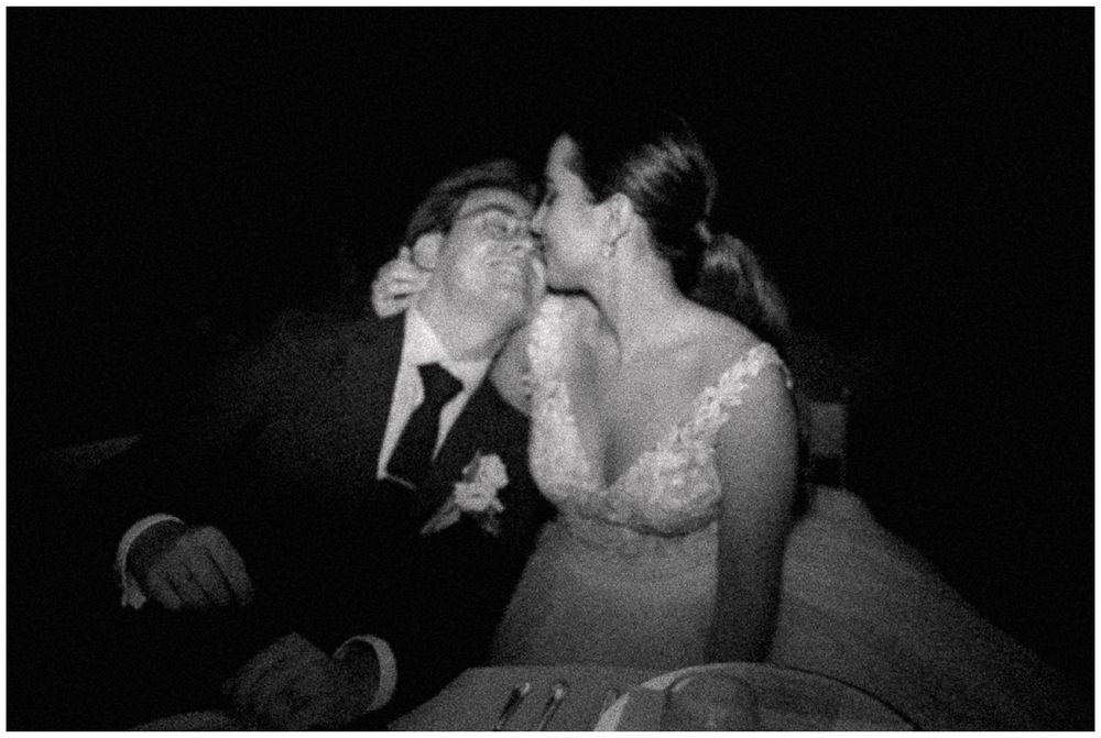 Black and white photo of newlyweds sharing a sweet moment in a vintage style photo.