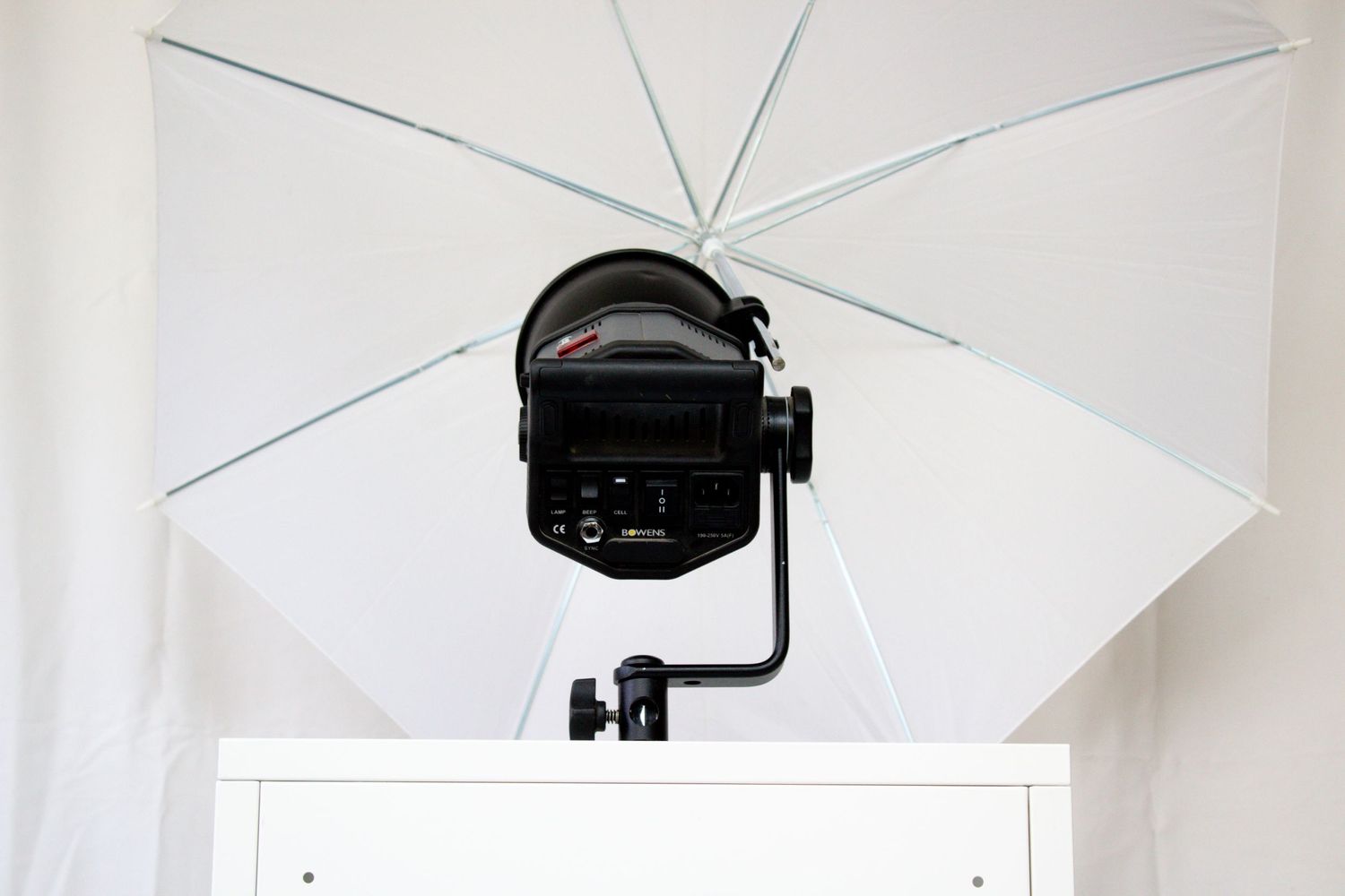 Professional photography setup with white umbrella light modifier mounted above white surface. Perth WA Photo booth Hire Event Booth