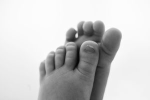 Artistic black and white close-up of newborn baby toes.