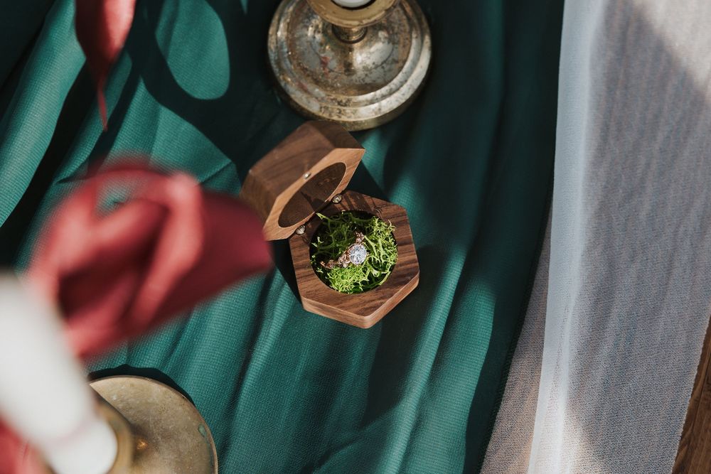 Overhead view of a green marble table with various food items and drinks arranged in an elegant dining setting.