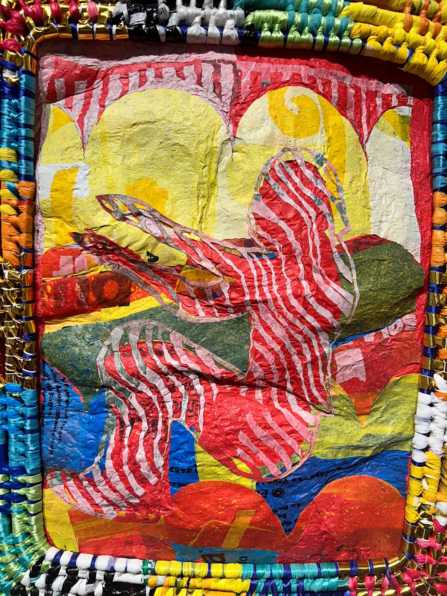 Vibrant plastic artwork bags depicting a figure in red and white stripes against a colorful geometric background.