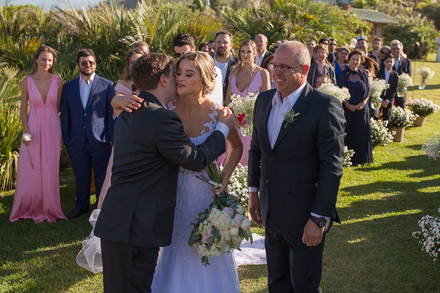 Wedding ceremony moment captured during an emotional exchange on a grassy hillside venue.