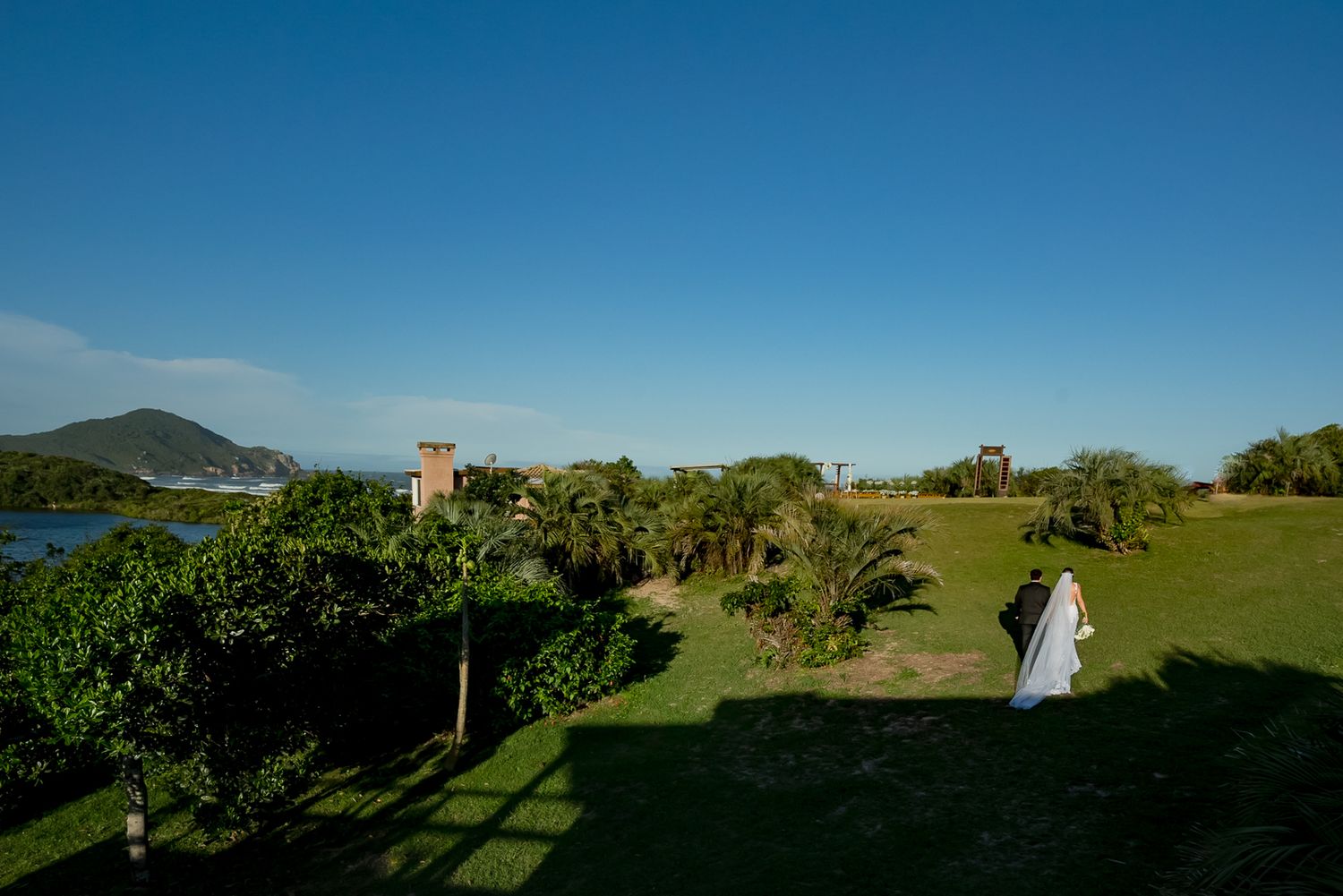 Aerial view of wedding ceremony location on coastal grounds with ocean backdrop.