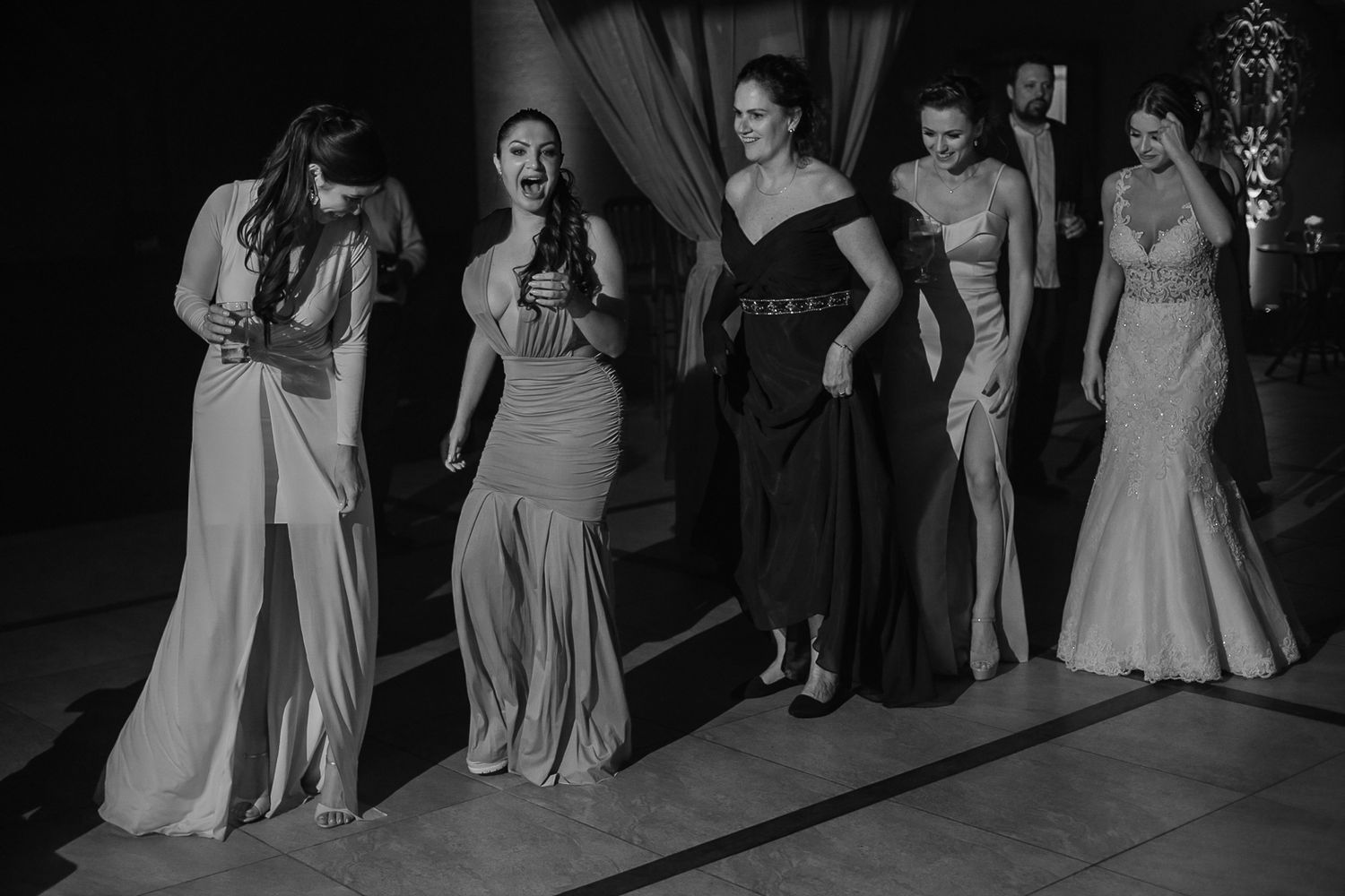 A group in formal attire posing together at an evening event.