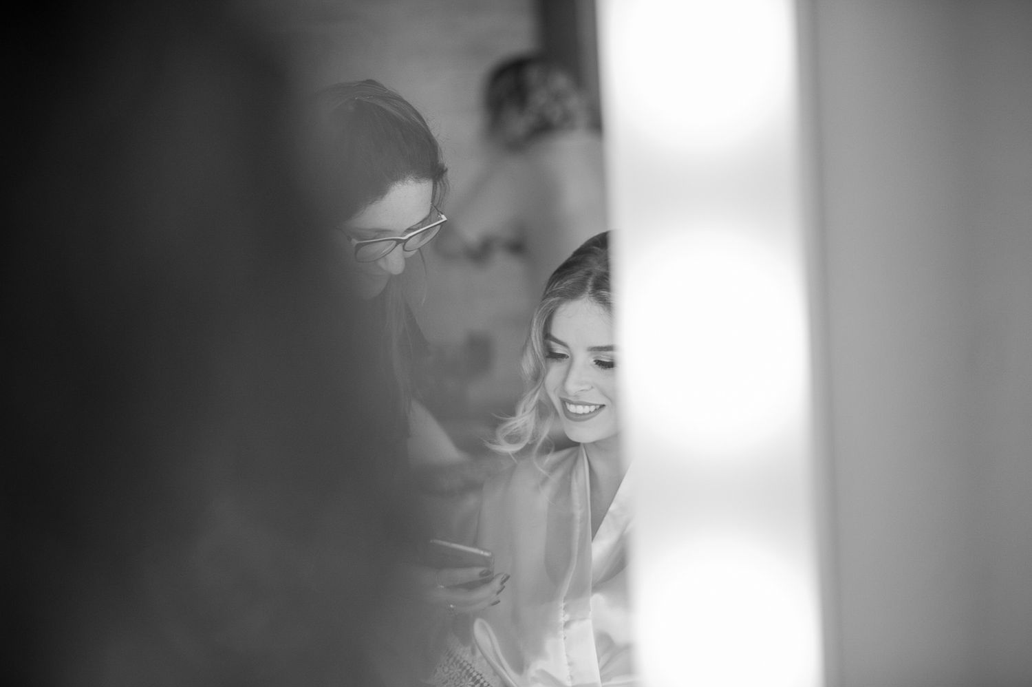 Artistic black and white photo capturing candid moment through reflections and shadows.