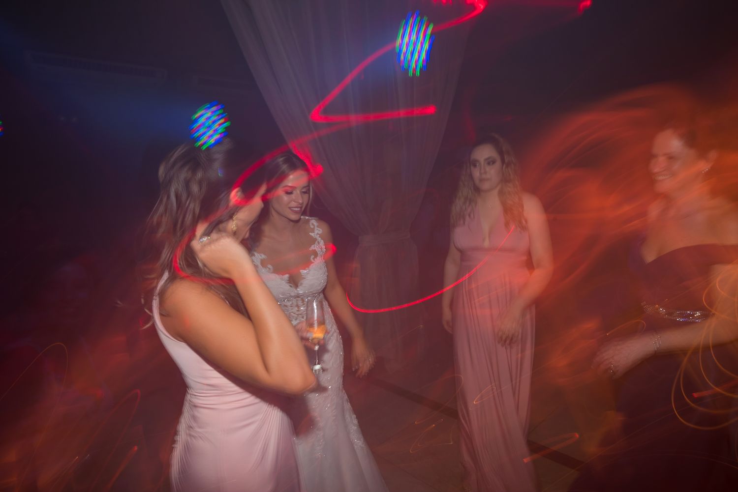 Dance party scene with colorful lighting effects and multiple people celebrating.