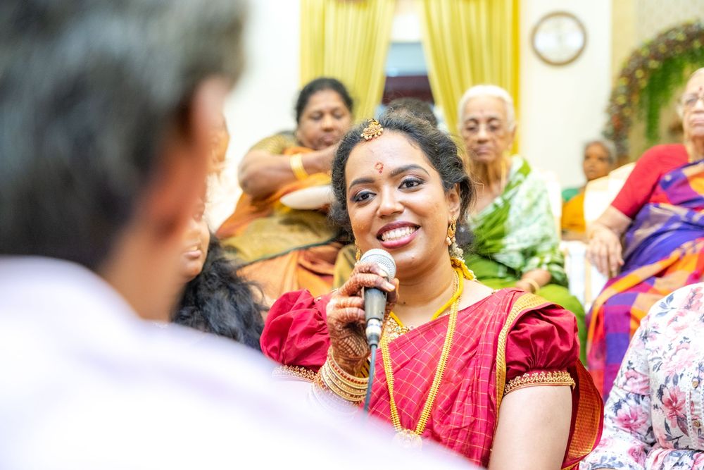 A celebration scene with guests in vibrant Indian traditional clothing at an indoor gathering.