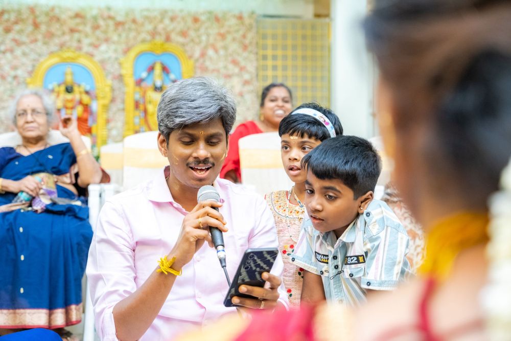 A group gathered at a celebratory event sharing stories and looking at mobile phones.