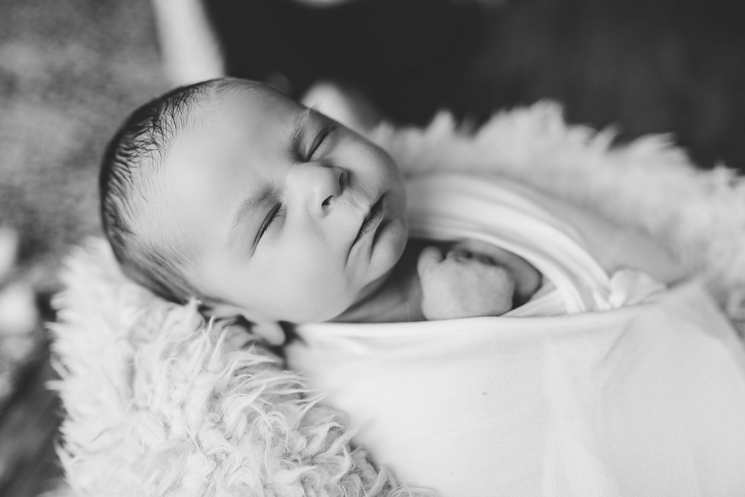 Peaceful newborn baby sleeping on white fluffy blanket in natural light. Photographer. Hull. East Yorkshire. Photography