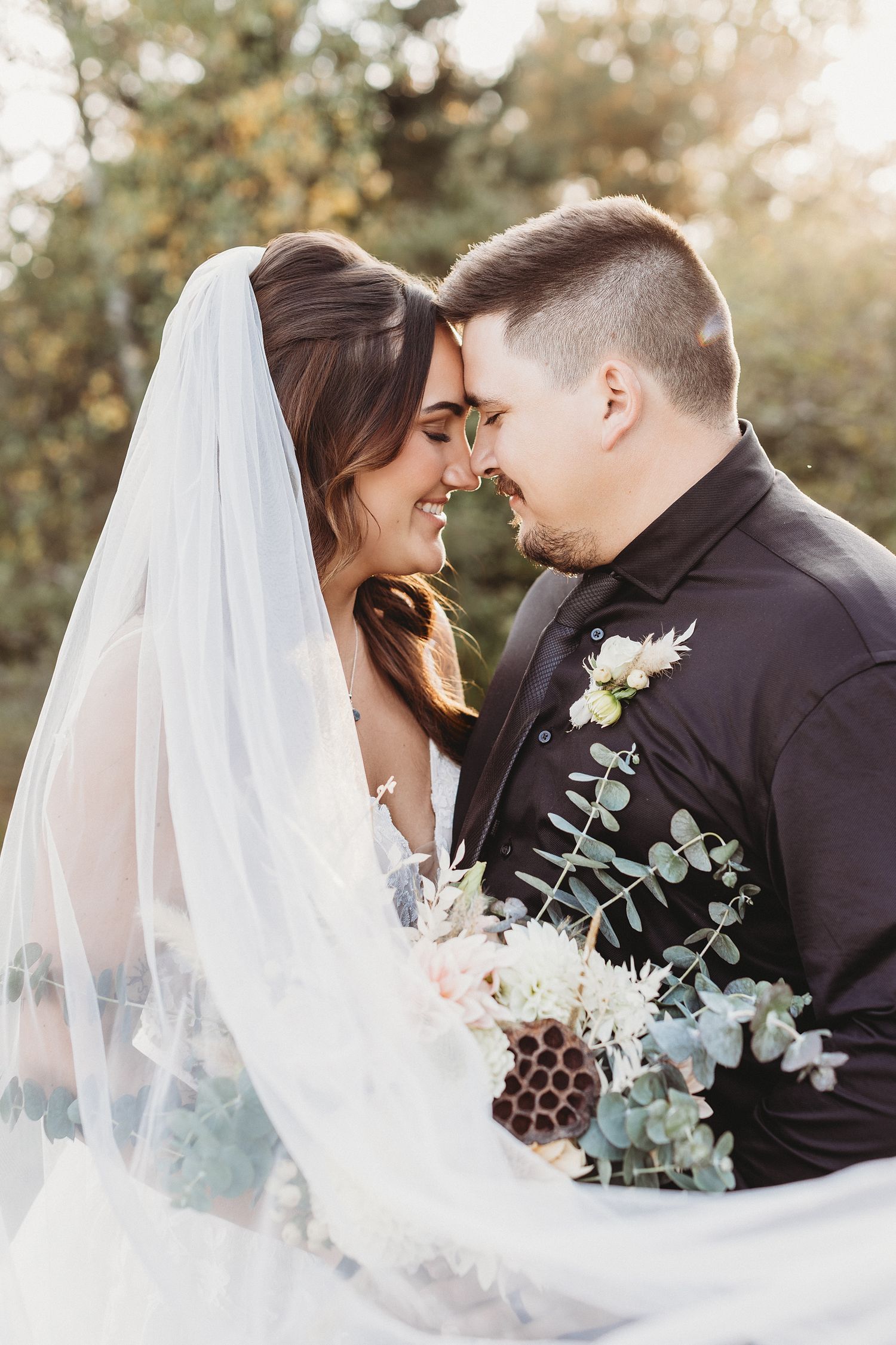 Professional photo of an engaged couple holding each other on the beach