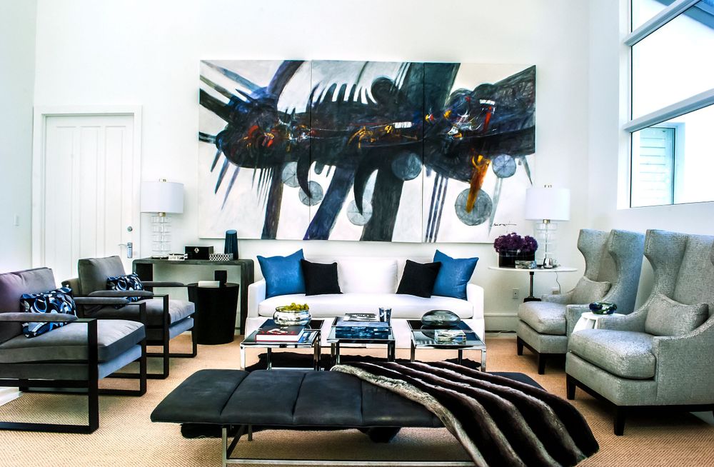 Modern living room with gray sofas, black coffee table, and striking black wall art featuring a dinosaur silhouette.